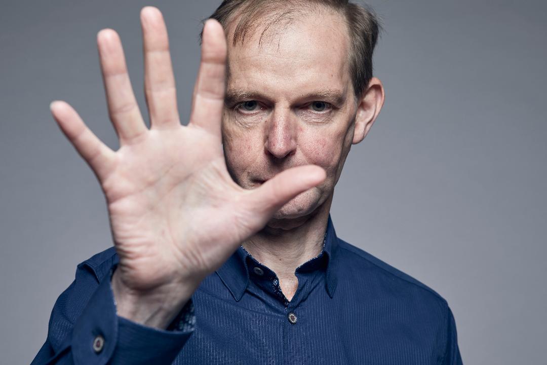 A photo of Daniel holding his hand up 