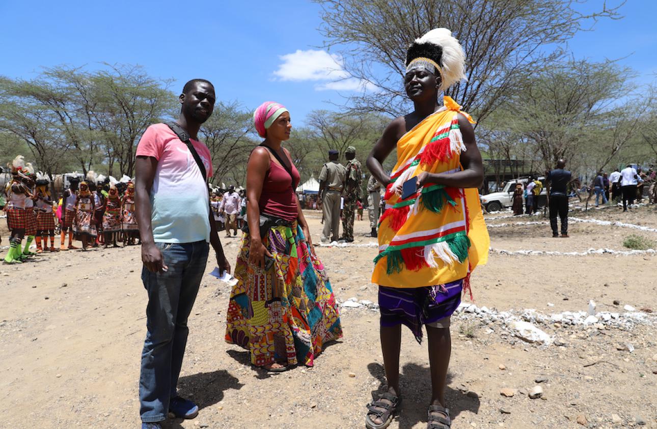 Storytellers John Namai (left) and Mara Menzies converse with Turkana musician Sammy Epungure at the Lokiriama Peace Accord Commemoration in Lokiriama, Turkana County,Kenya